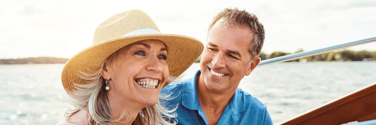 A smiling couple relaxing on a boat